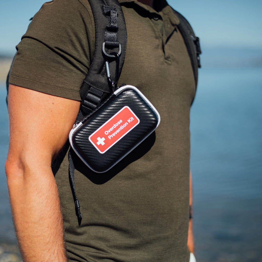 Overdose prevention kit attached to backpack strap