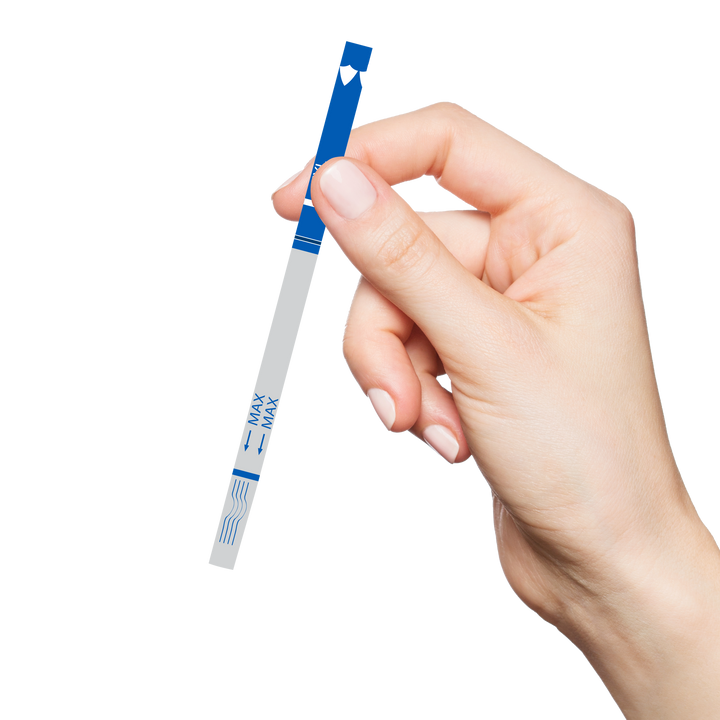 Hand holding a test strip for overdose detection