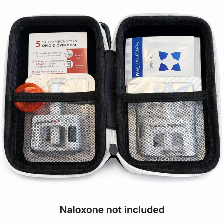 Open overdose prevention kit with test strips and supplies inside