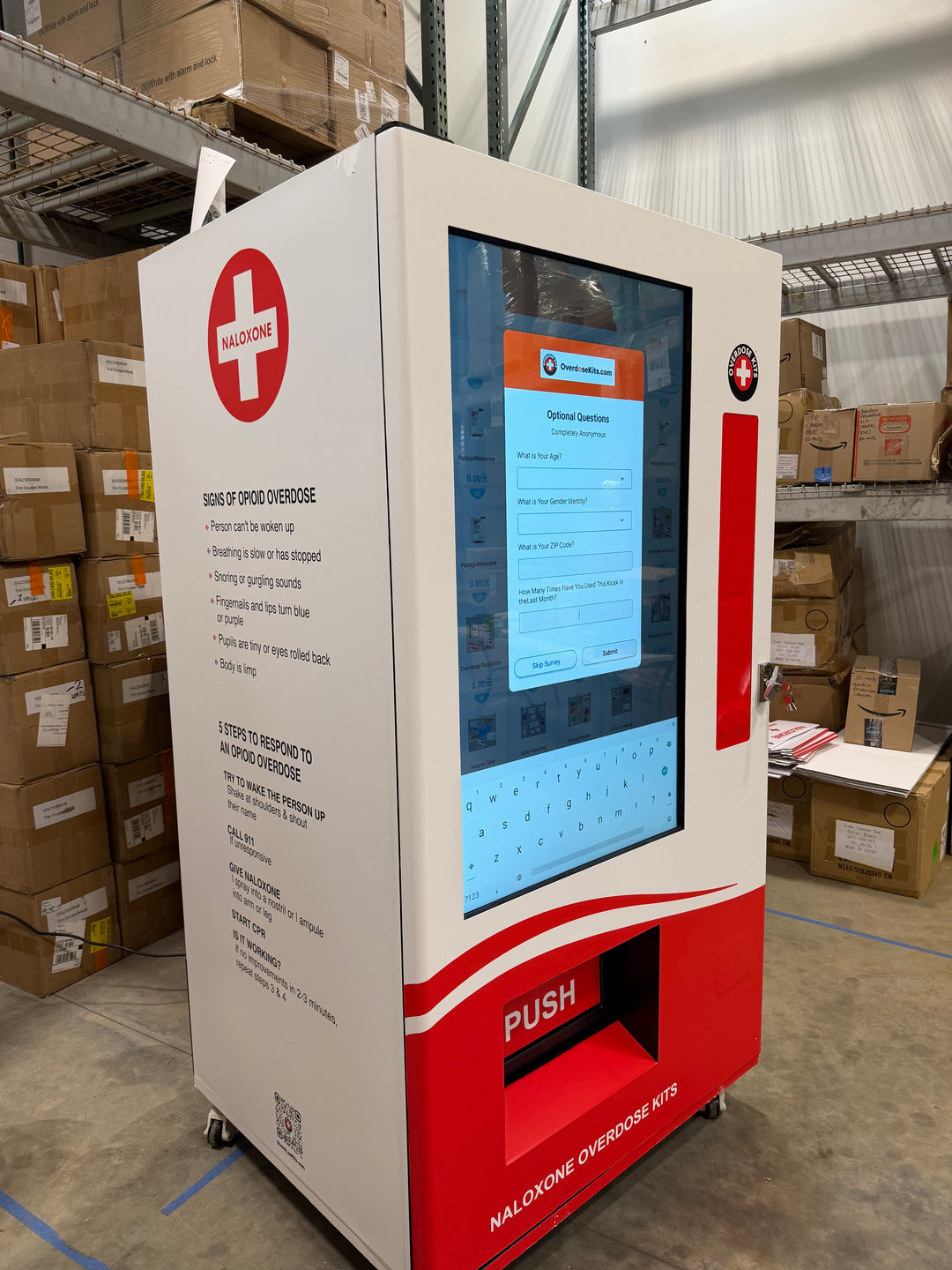 Red and white machine with a screen in a warehouse setting