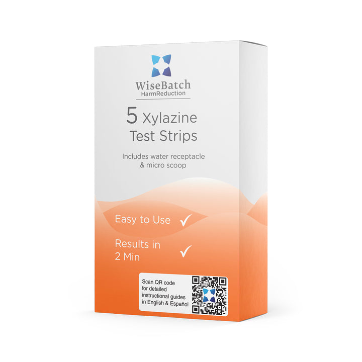 Box of 5 WiseBatch Xylazine (XYL) test strips for harm reduction. Packaging includes water receptacle and micro scoop, featuring a QR code for instructional guides in English and Spanish. Designed for results in 2 minutes.