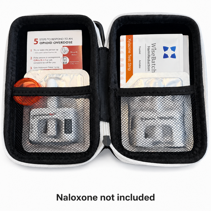Open first aid kit with medical supplies on a white background