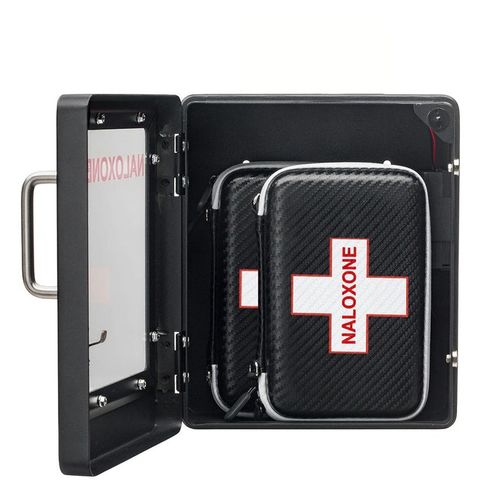 Overdose Kits black wall mount cabinet with two Naloxone emergency kits inside. Each kit has a white cross with red border and text.